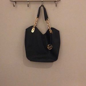 MICHAEL KORS NAVY HAND BAG WITH GOLD STRAPS